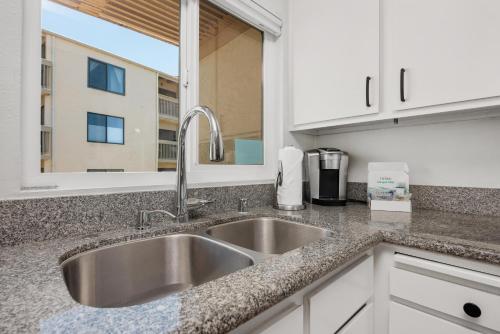 a kitchen counter with a sink and a window at Once Upon A Tide - SBTC312 in Solana Beach