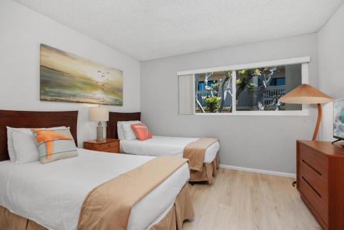 a hotel room with two beds and a window at Once Upon A Tide - SBTC312 in Solana Beach