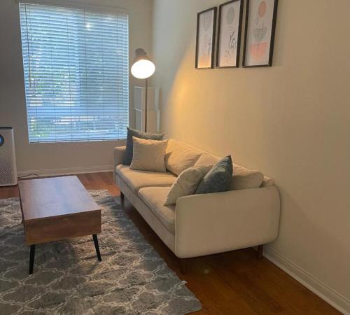 a living room with a couch and a coffee table at LALAs House- 1br with Free Parking, Pool and Sauna in Los Angeles