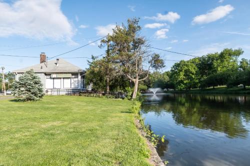 a house next to a river with a building at Luxury Apt in Passaic