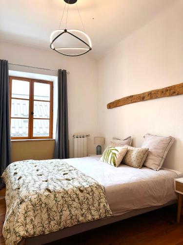 une chambre avec un lit et une grande fenêtre dans l'établissement Auberge Le Glacier Bleu, à Mont-Dauphin