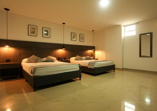 Postel nebo postele na pokoji v ubytování Hotel California Medellin