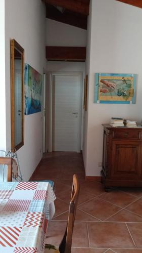 a room with a table and a cabinet and a door at Buena Vista in SantʼAntìoco