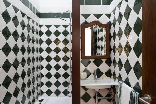 a bathroom with a sink and a mirror at Casas de São José in Rio Maior