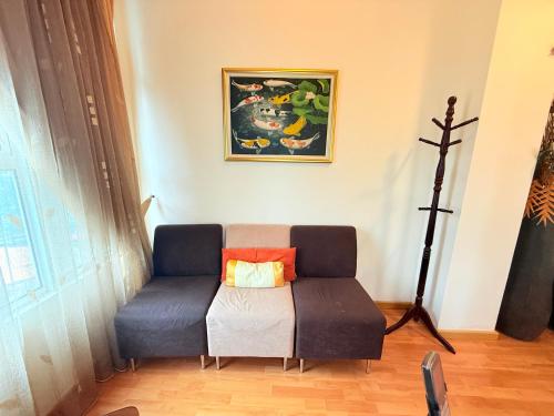a couch sitting in a living room with at Park View Service Apartment By Kualalampur in Kuala Lumpur