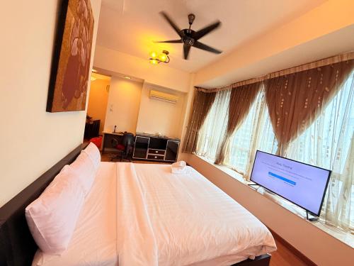 a bedroom with a bed with a ceiling fan and a window at Park View Service Apartment By Kualalampur in Kuala Lumpur