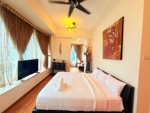 a bedroom with a bed and a flat screen tv at Park View Service Apartment By Kualalampur in Kuala Lumpur