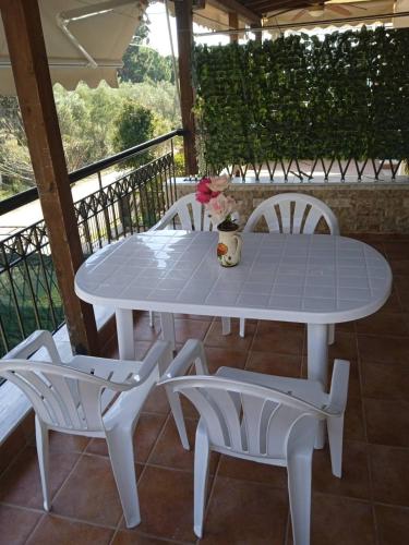 a white table and two chairs on a porch at MyseA Lovelight Kalyves in Kalyves Poligirou