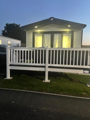 a white fence in front of a house at Willerby lamberhurst in Westgate-on-Sea