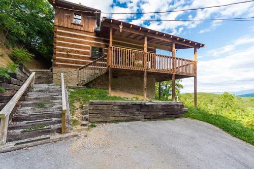 a log cabin with a porch and stairs in front at View! Private! Hot Tub,Pool Table,Fireplace,RELAX! in Sevierville
