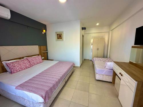 Postel nebo postele na pokoji v ubytování ADASU Otel
