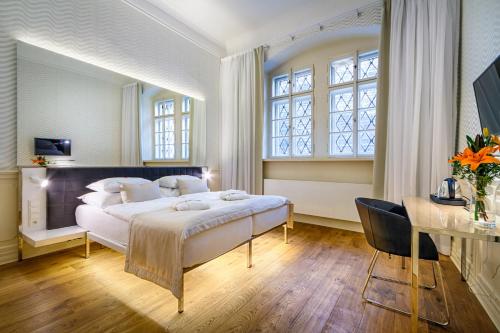 a bedroom with a large bed and a desk at Golden Star in Prague