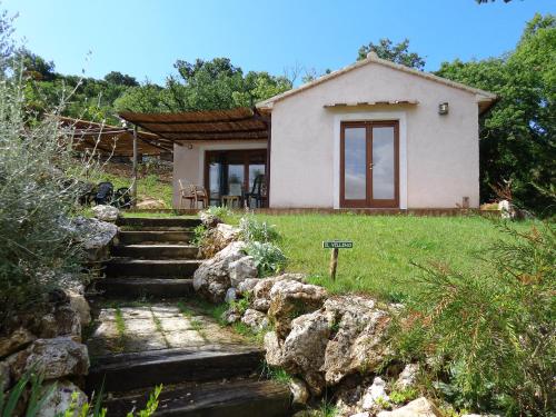 a small house with stairs in front of it at Agriturismo Fontenuova in Saturnia