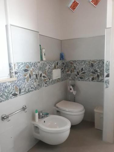 a bathroom with a toilet and a sink at Buena Vista in SantʼAntìoco