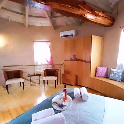a living room with a table and chairs in a room at Anemomilos Villa in Asprogerakata