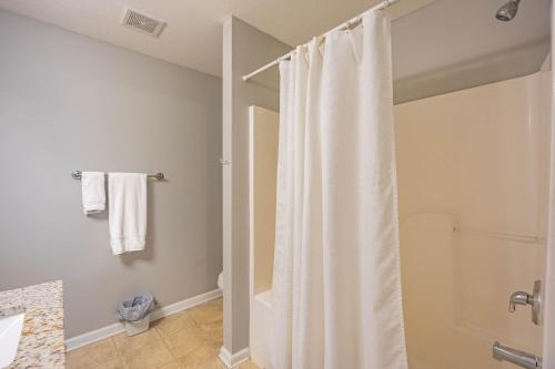 a bathroom with a shower with a white shower curtain at Charming Gray Home- 5 mins from GSU! in Statesboro