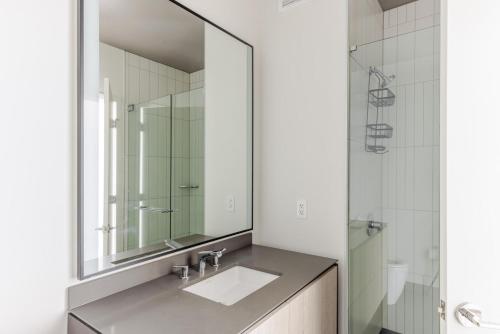 a bathroom with a sink and a mirror at Blueground Central Station pool nr Grant Park CHI-1242 in Chicago