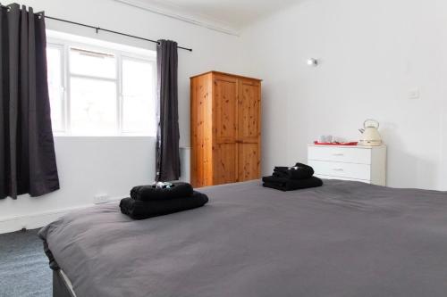 a bedroom with a bed and a window and a dresser at Pebbles Guest House Room 1 in Southampton