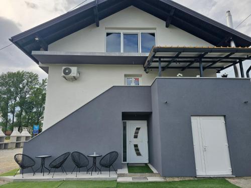 a house with chairs and a table in front of it at ENA 1&2 -BIG FREE PRIVAT parking for BOATS, TRUCKs, combi,-CENTRAL HEATING !!! in Karlovac