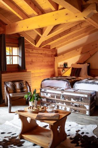 a bedroom with two beds in a log cabin at Hôtel Chalet Mounier in Les Deux Alpes