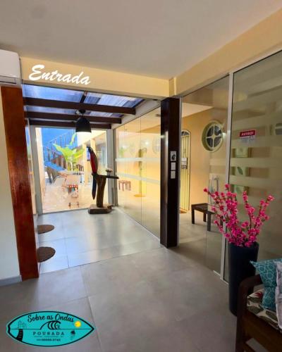 a lobby of a hotel with a view of a beach at Pousada Sobre as Ondas in Saquarema
