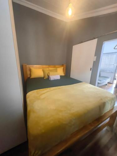 a bedroom with a large bed in a room at The Cozy Cabin in Pretoria