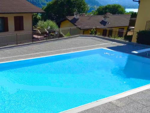 a swimming pool with blue water in a house at Lakefront Apartment with Panoramic Pool in Ranzanico