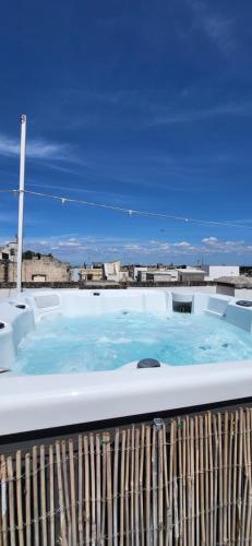 a hot tub sitting on top of a balcony at Giulia's House in Galatina