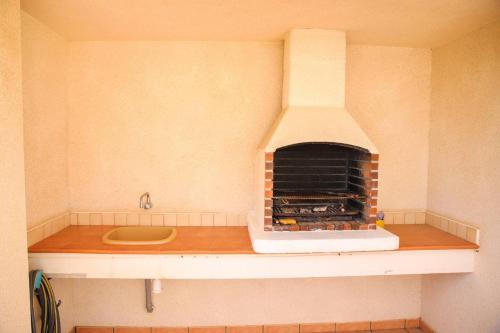 a kitchen with a brick oven on a counter at Atico Piles in Piles