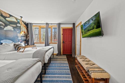 a room with two beds and a red door at Green Acres Retreat in Hancock