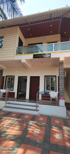 a house with a balcony with a bed in it at HOME 2 by HIS GRACE, Near to Malpe Beach in Udupi