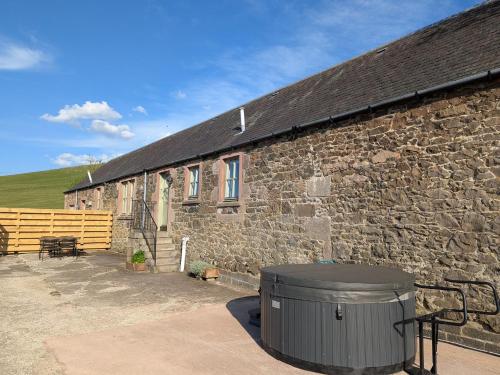 a stone building with a trash can in front of it at 2 Bed in Biggar 95516 in Biggar