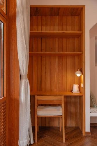 a room with a book shelf and a desk at The Jam Boutique Hotel in Luang Prabang