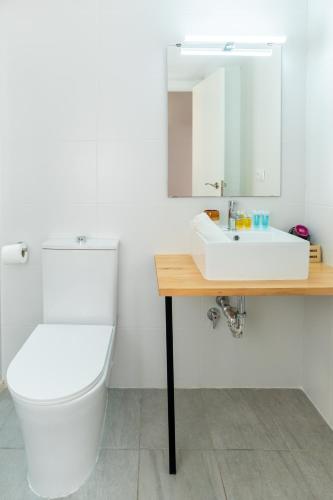 a bathroom with a toilet and a sink and a mirror at Iaia Carmen in Tabarca