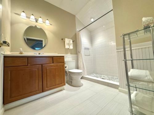 a bathroom with a shower and a sink and a toilet at Inn on Main Hotel in Manasquan