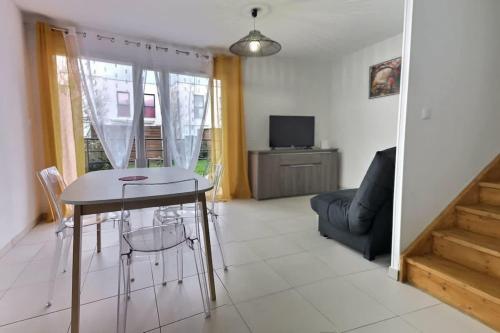 un salon avec une table et un canapé dans l'établissement Villa moderne avec 2 chambres dans une résidence à 500m de la plage, à Sérignan