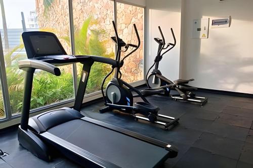 two exercise bikes in a gym with a window at Vista impresionante y cama king en Baia Kristal in Los Arrayanes