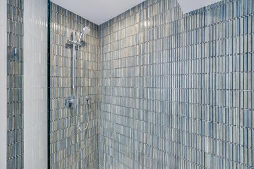 a shower in a bathroom with a building at Harwich Getaway in Harwich