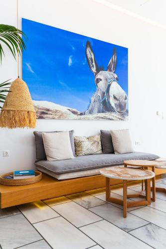 a painting of a donkey on a wall in a living room at Golden Beach Hotel in Chrissi Akti