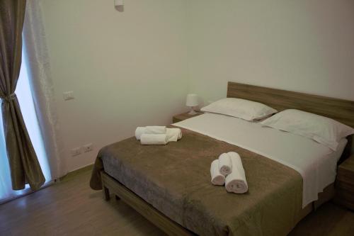 a bedroom with a bed with two towels on it at Oasi del mare in Fiumicino