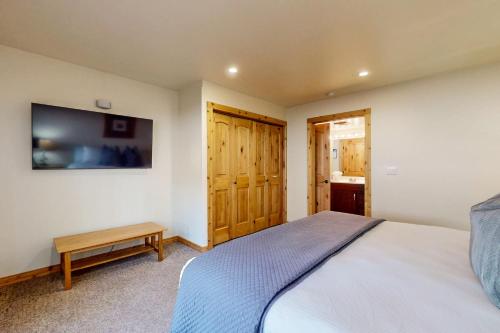 a bedroom with a bed and a tv on the wall at Basecamp Bliss in Olympic Valley