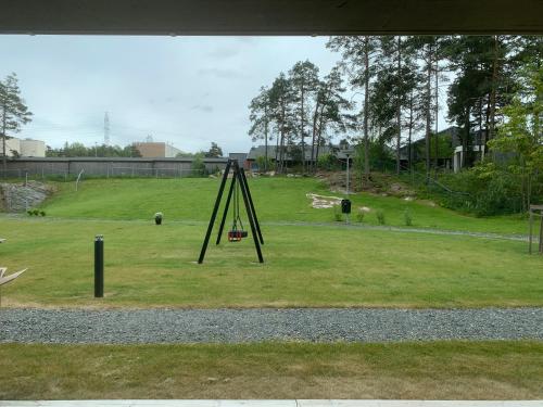a swing set in a field of grass at Bedroom&ensuite in Moss