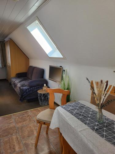 a living room with a couch and a table at Kleiner Leuchtturm Kühlungsborn in Kühlungsborn