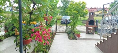 a garden with flowers in pots and a gate at Apartman Tina in Zagreb
