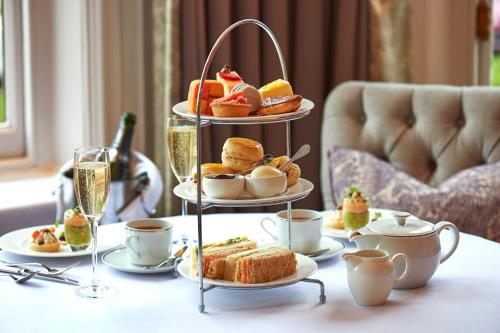 a three tiered tray of pastries and desserts on a table at The Milner York in York