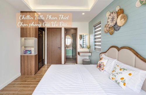 a bedroom with a bed with a sign on the wall at Chillin Villa Novaworld Phan Thiet in Bình Tú