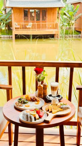 a table with two plates of food on it at The Jam Boutique Hotel in Luang Prabang