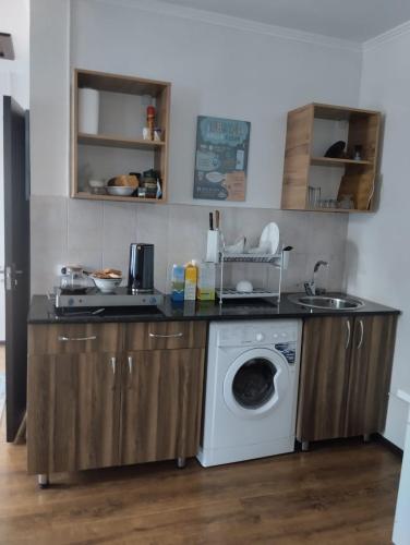 a kitchen with a washer and a washing machine at Арчалуу in Akchiy