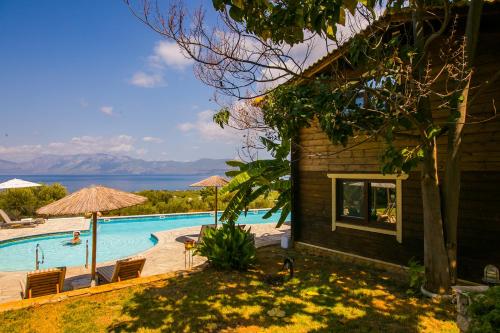 a house with a swimming pool with a view of the water at Anthidon Nature Estate & Farm in Chalkida