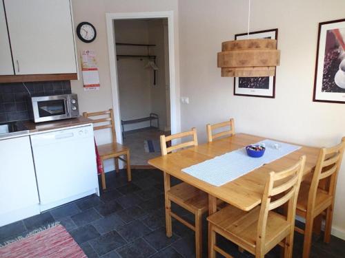 a kitchen with a wooden table and chairs in a kitchen at Åreguiderna - Bubblans lägenheter Åre Torg in Åre